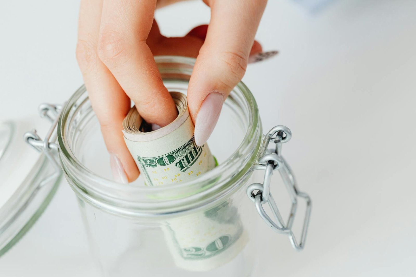 Glass jar filled with cash representing an emergency fund for financial security